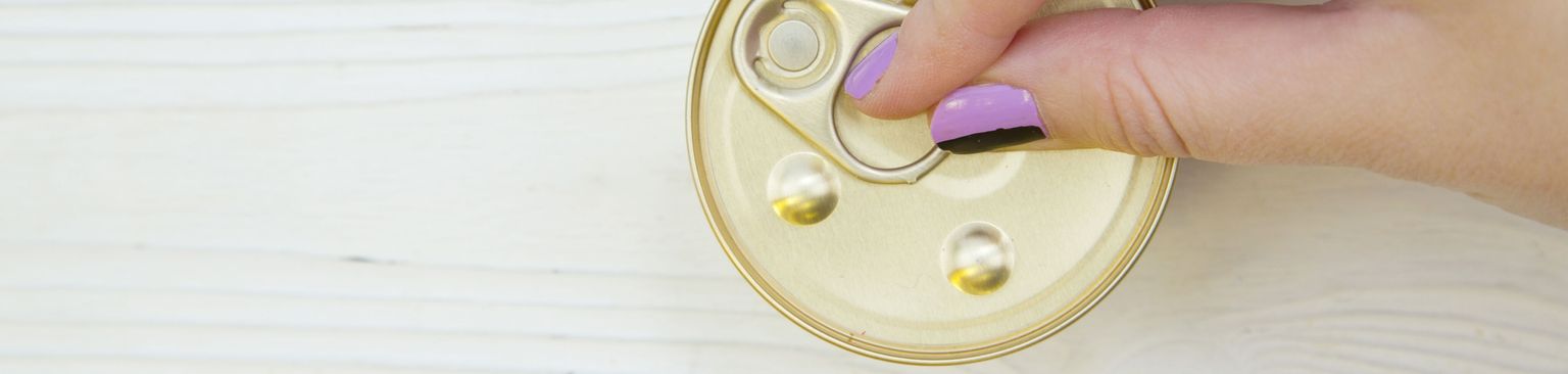 Woman opens dog food can Button,Skin,Yellow,Hand,Finger,Fashion accessory,Coin purse,Wood,Circle,Table,