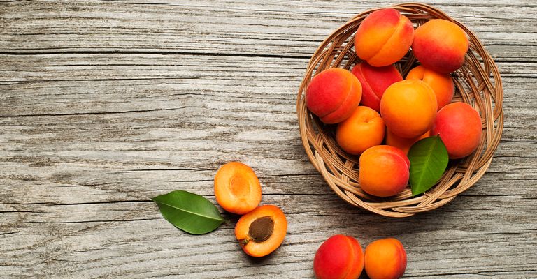 Fresh cut apricot fruit on wooden background