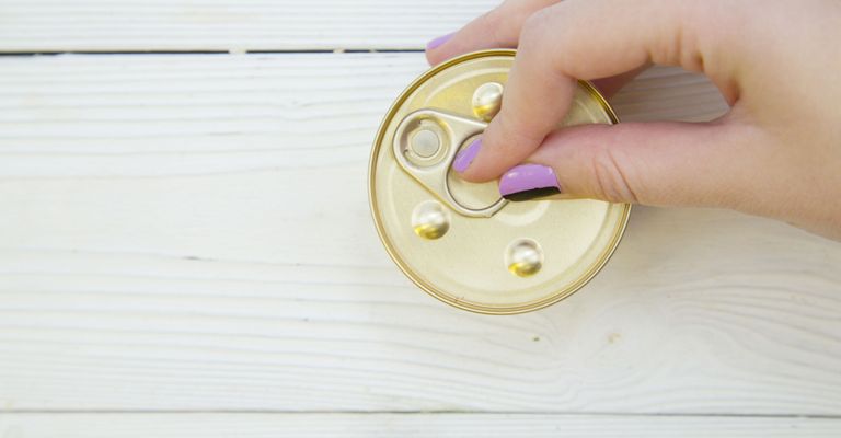 Button,Skin,Yellow,Hand,Finger,Fashion accessory,Coin purse,Wood,Circle,Table,