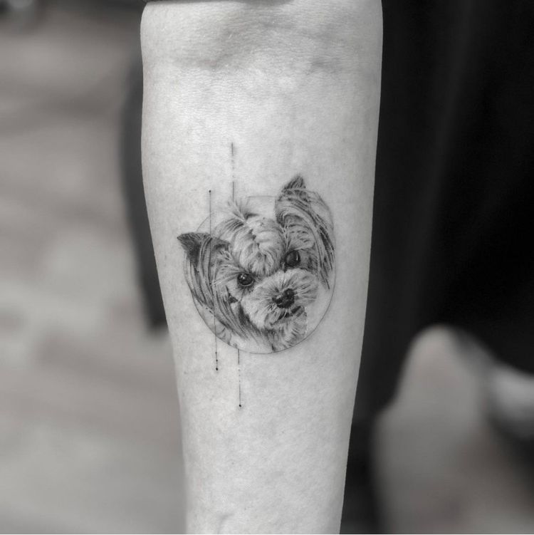 Dog head tattooed on forearm, dog head of Maltese or small dog breed, modern petite tattoo, dog tattoo